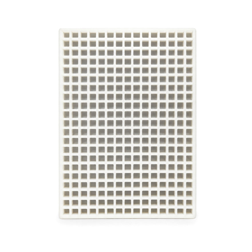 Top view of a commercial silicone candy mold with many square cavities