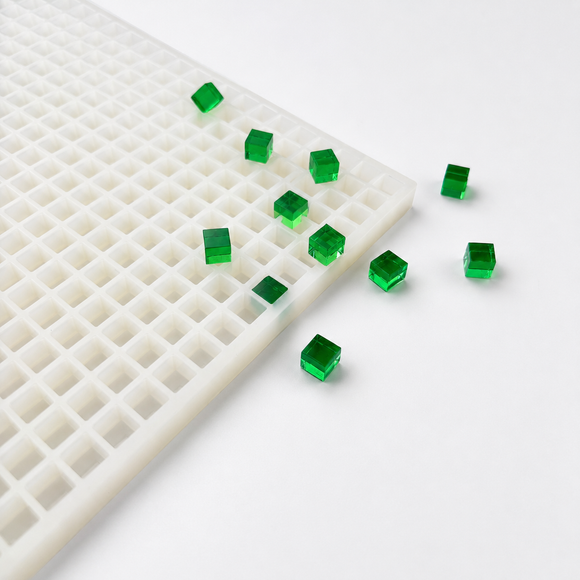 Angled view of a 1mL cube gummy mold with emerald green cube gummies
