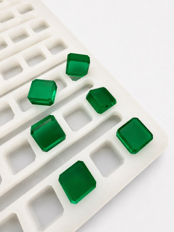 Close-up of a 2.3mL universal depositor cube gummy mold with 136 cavities and smooth emerald green cube gummies on a white background
