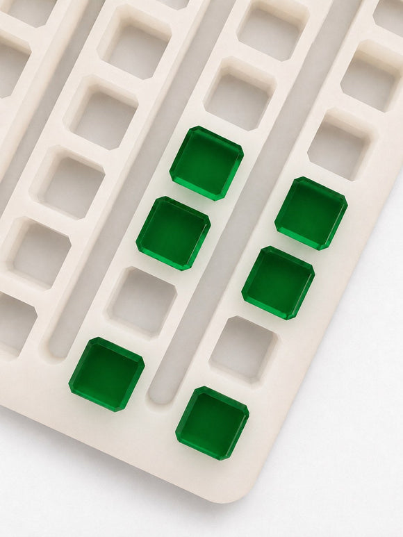 Top view of a 2.3mL universal depositor cube gummy mold with 136 cavities and smooth emerald green cube gummies on a white background