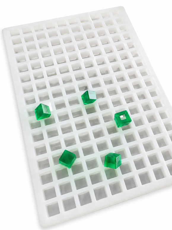 Angled view of a 2.625mL square gummy mold with 266 cavities and translucent emerald green square gummies on a clean white background
