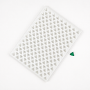 Angled view of a 2mL diamond gummy mold with 179 cavities and an emerald green gummy on a white background