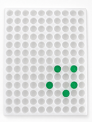 Top view of 3.8mL coin gummy mold with 130 round cavities and green gummies