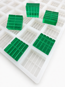 Close-up of 7.5mL 10-piece square breaker silicone gummy mold with emerald green segmented gummies