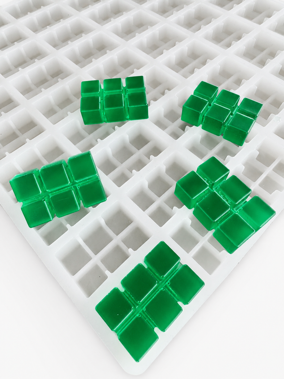 Close-up of 9.35mL 6-piece brick breaker silicone gummy mold with emerald green segmented brick gummies